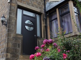 Pisa composite door in Black with Abstract glass and integrated side panels and top lights.