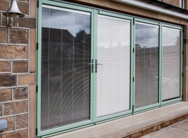 Aluminium bi-fold doors in Chartwell green with integral blinds, Newsome