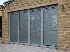 Light grey aluminium bi-fold doors with integral blinds